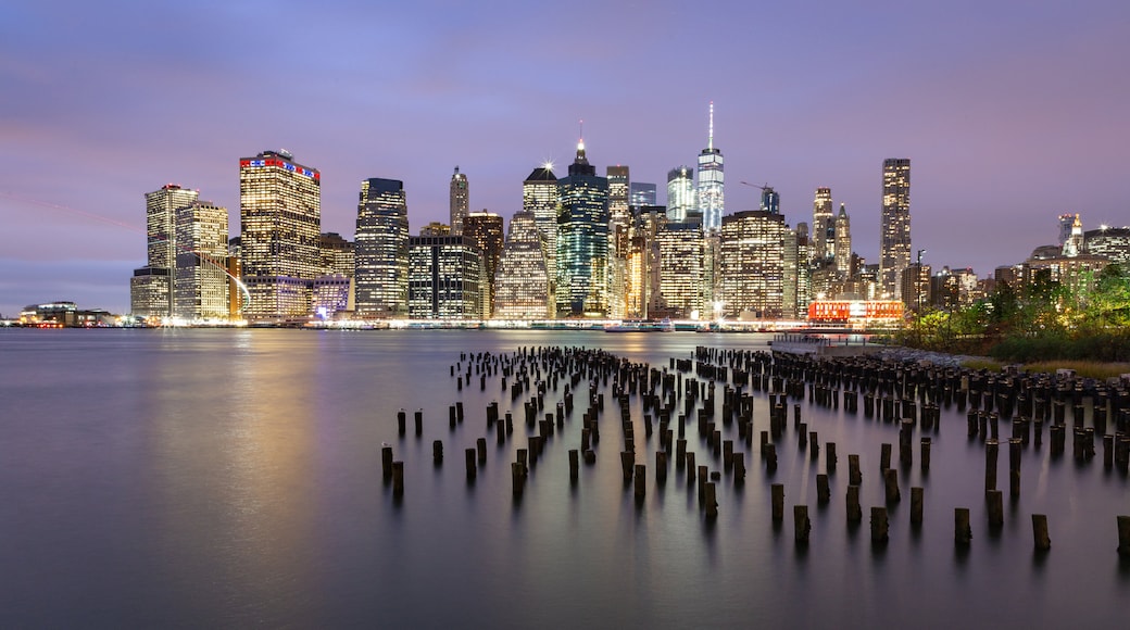 Brooklyn Bridge Park showing a city, night scenes and a sunset