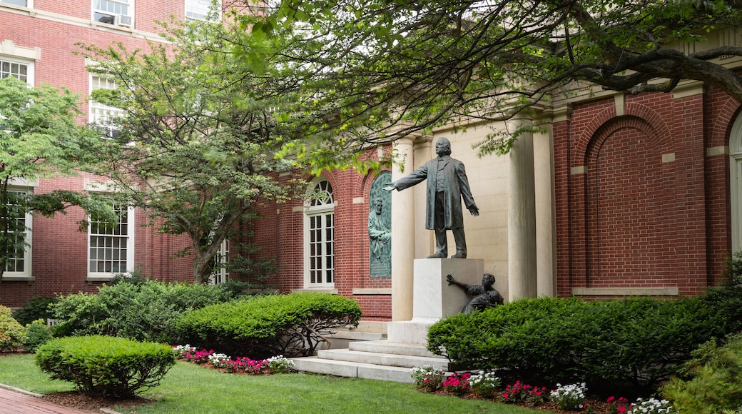 Plymouth Church featuring a statue or sculpture, a park and flowers