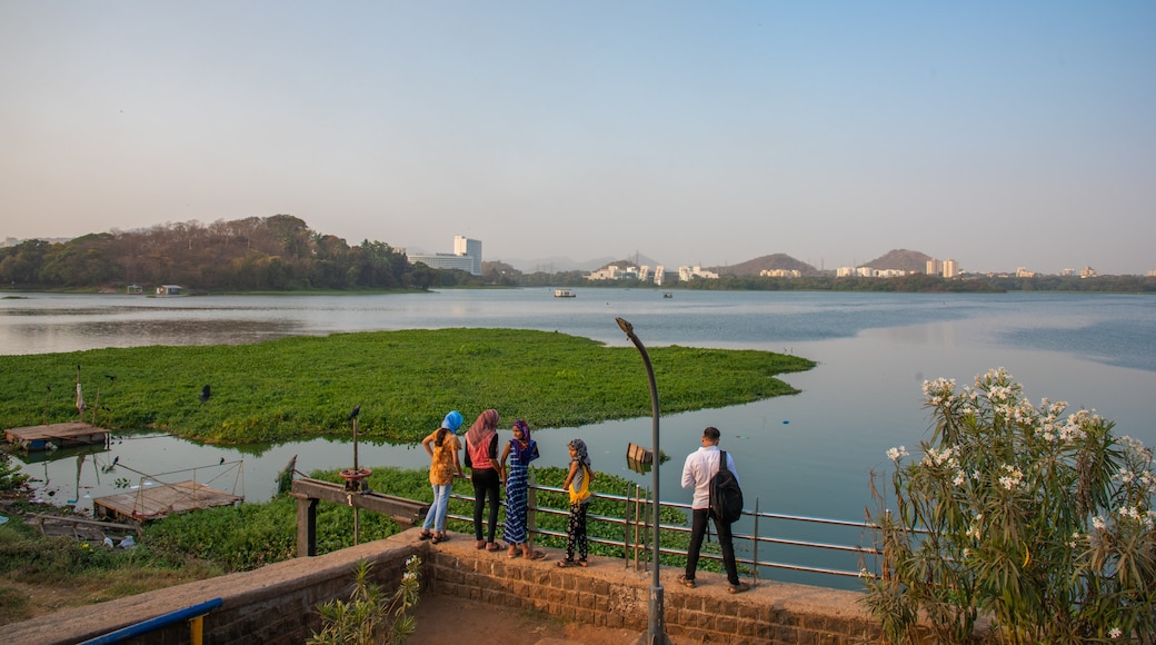 Powai Lake showing a river or creek and views as well as a small group of people