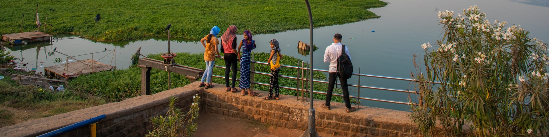 Powai Lake showing a river or creek and views as well as a small group of people