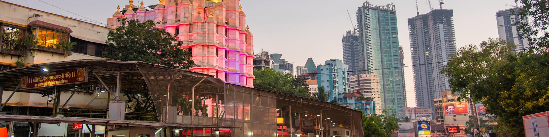 Siddhi Vinayak Temple which includes a city, heritage architecture and a sunset