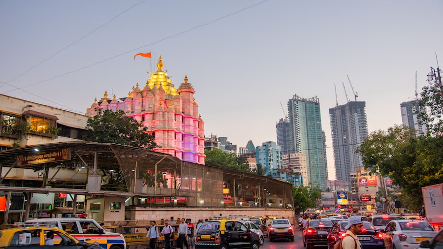 Siddhi Vinayak Temple which includes a city, heritage architecture and a sunset