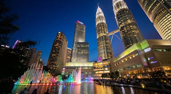 KLCC Park featuring a high rise building, night scenes and a fountain