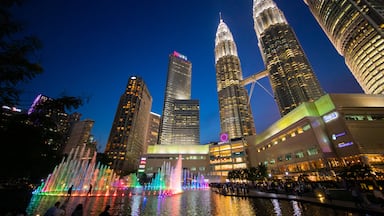 KLCC Park featuring a high rise building, night scenes and a fountain