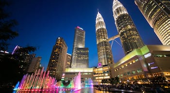 KLCC Park showing night scenes, a skyscraper and a city