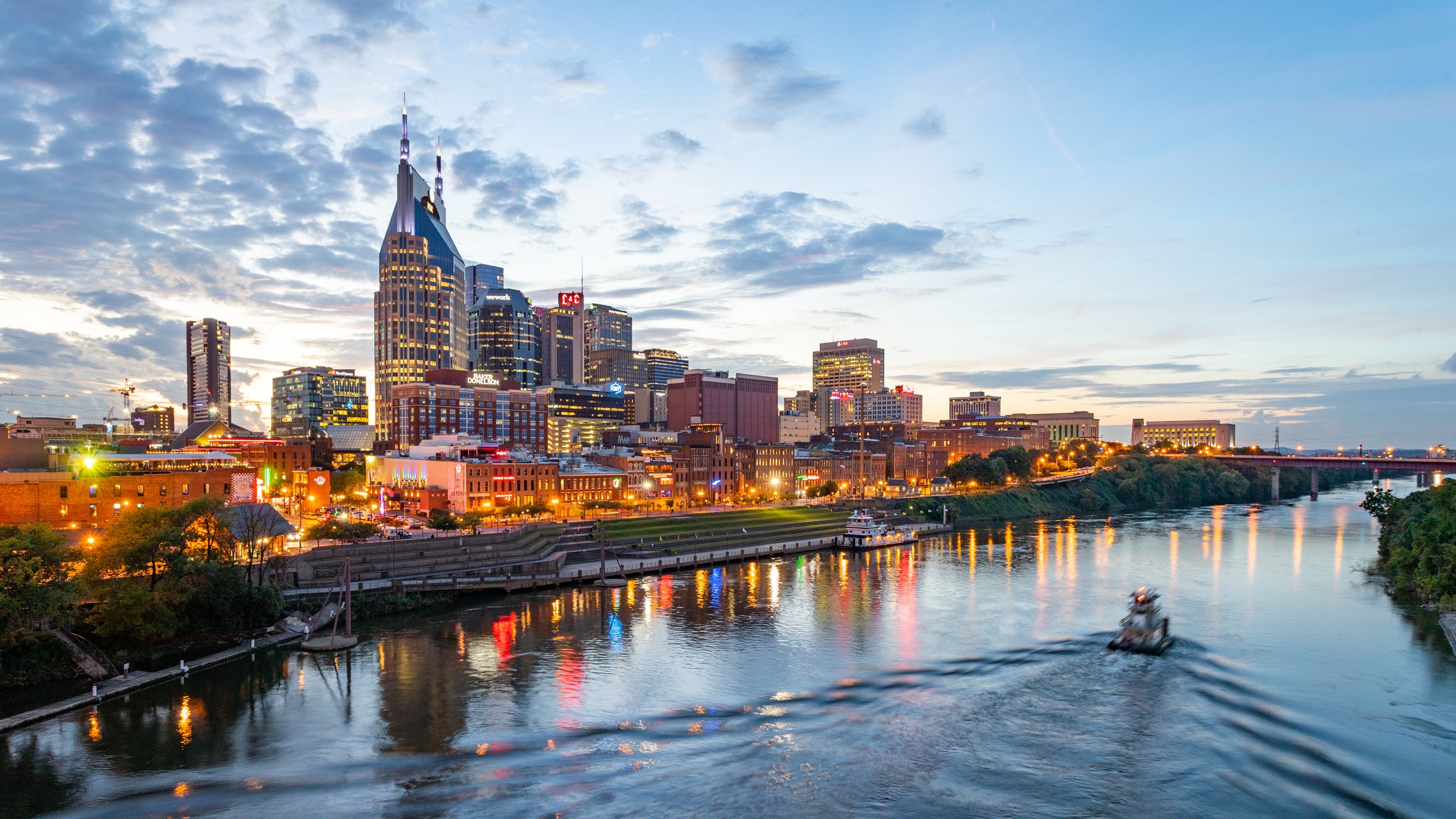 Downtown Nashville which includes a city, a sunset and boating