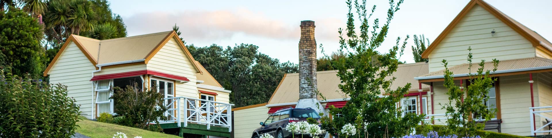 Mangonui featuring a small town or village, a sunset and flowers