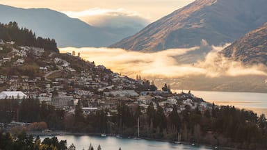 Queenstown which includes a sunset, mist or fog and a bay or harbor