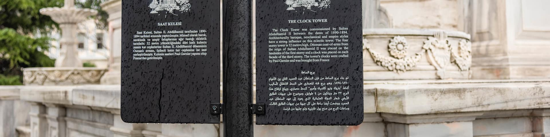 Dolmabahce Clock Tower which includes signage and heritage elements
