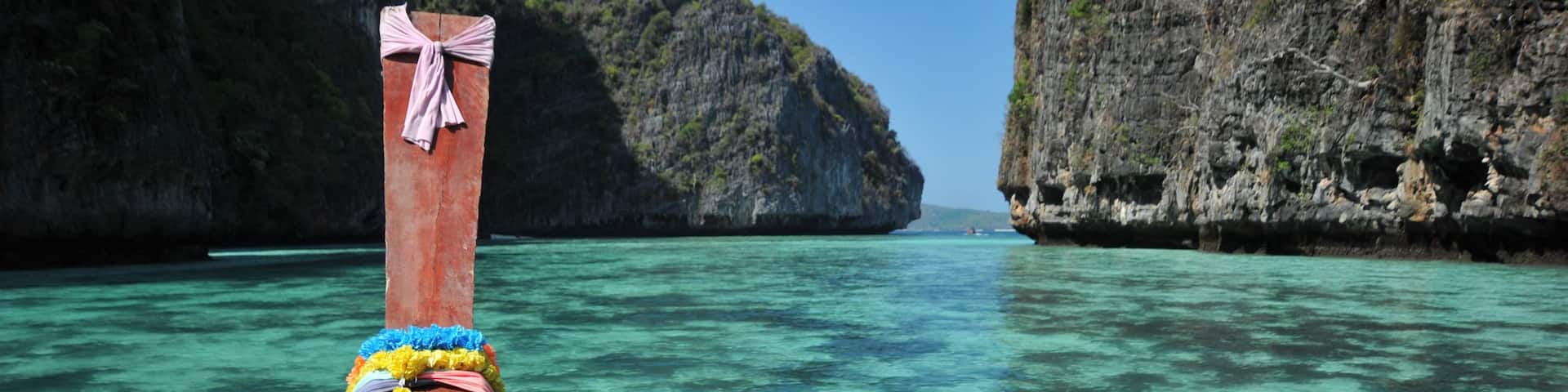 Phi Phi Islands featuring rugged coastline, boating and tropical scenes