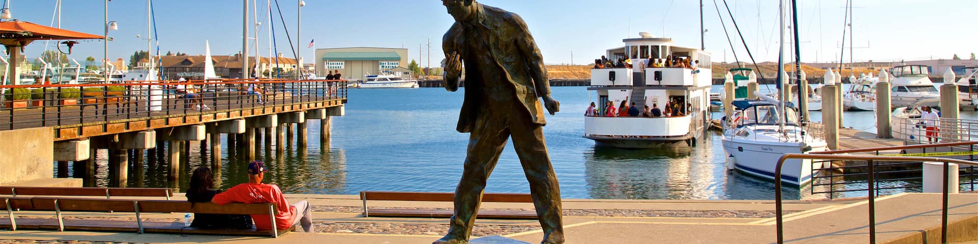 Jack London Square which includes a bay or harbor and a statue or sculpture