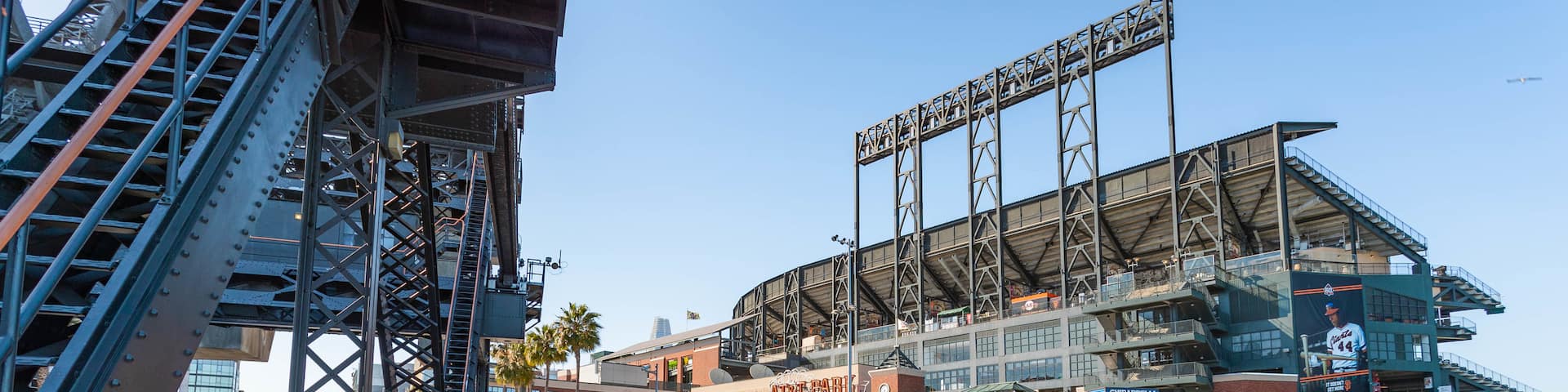 Oracle Park featuring a bay or harbor and street scenes as well as a small group of people