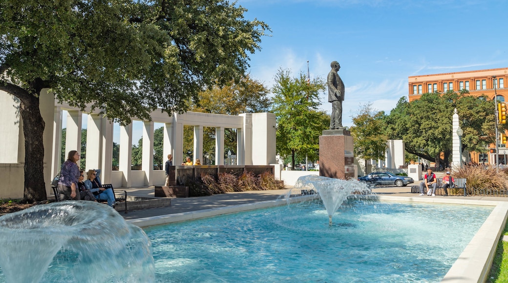 Dealey Plaza featuring a fountain and a statue or sculpture