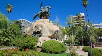 San Martin Square which includes wildflowers, a statue or sculpture and a park