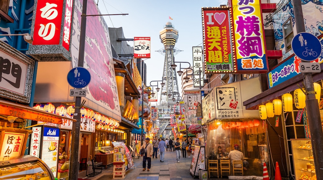 Tsutenkaku Tower which includes markets, a city and street scenes