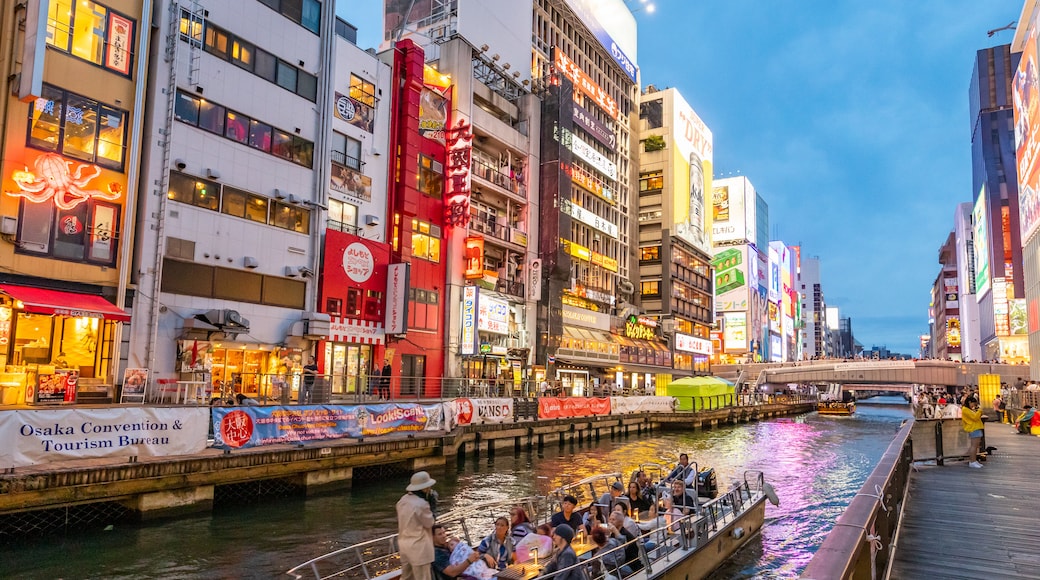 Dotonbori which includes boating, a city and a river or creek