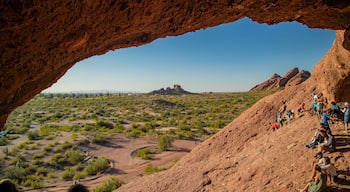 Papago Park featuring desert views as well as a small group of people