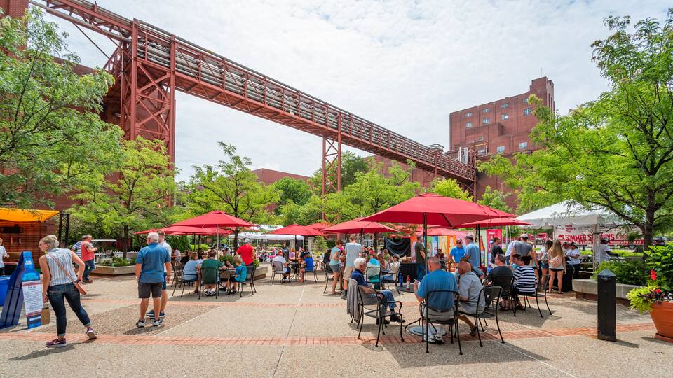 Anheuser-Busch Brewery which includes outdoor eating and a square or plaza as well as a small group of people
