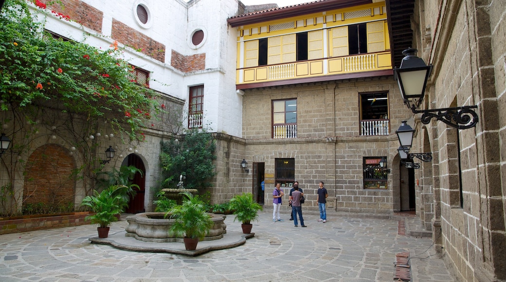 Casa Manila Museum which includes a square or plaza as well as a small group of people