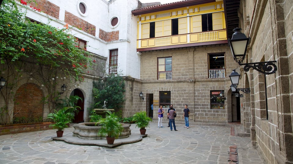 Casa Manila Museum which includes a square or plaza as well as a small group of people