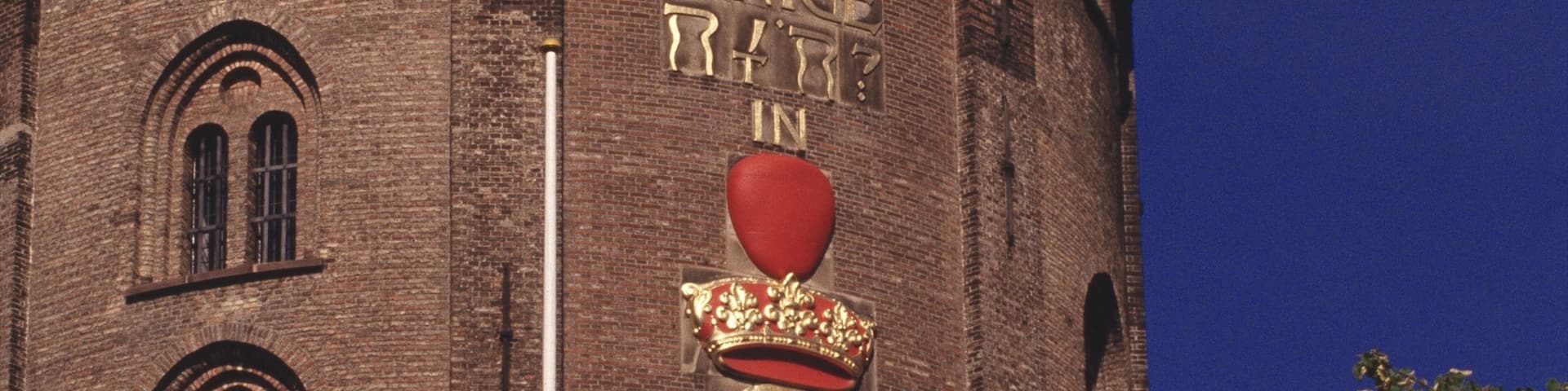 Round Tower featuring heritage architecture, an administrative buidling and signage