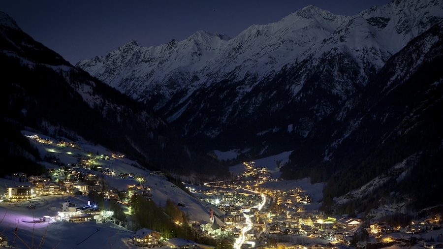 Austria which includes snow, mountains and a small town or village
