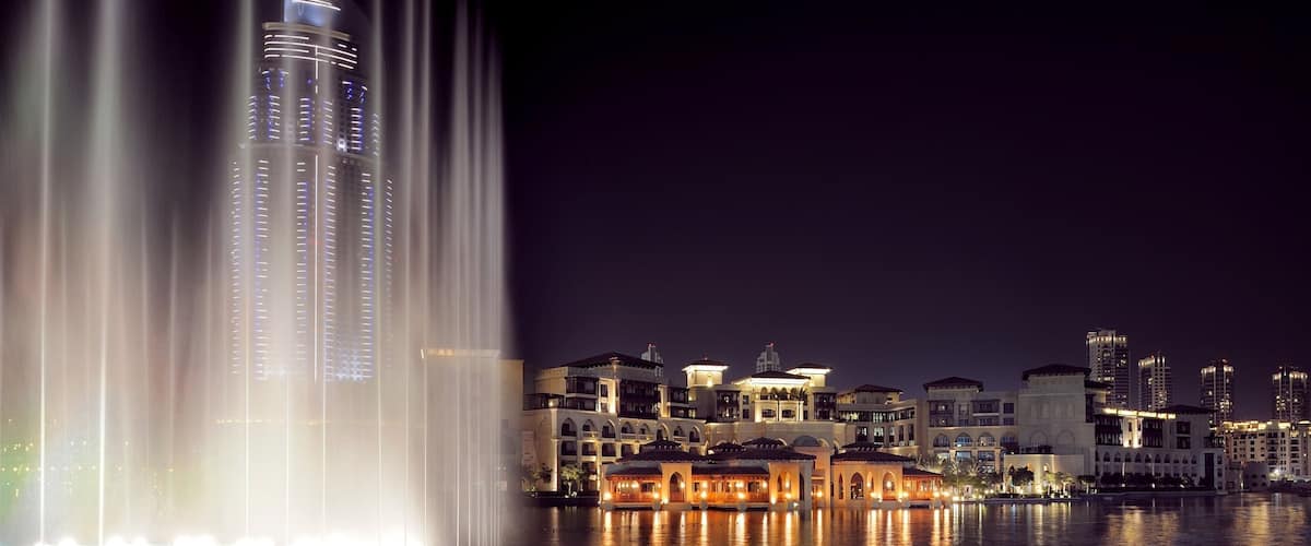 Dubai featuring a fountain, a skyscraper and a bay or harbour