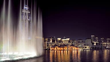 Dubai featuring a fountain, a skyscraper and a bay or harbour