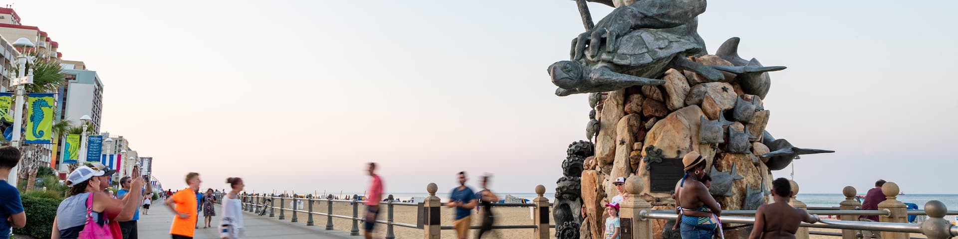 Neptune Statue which includes a sunset, street scenes and a statue or sculpture