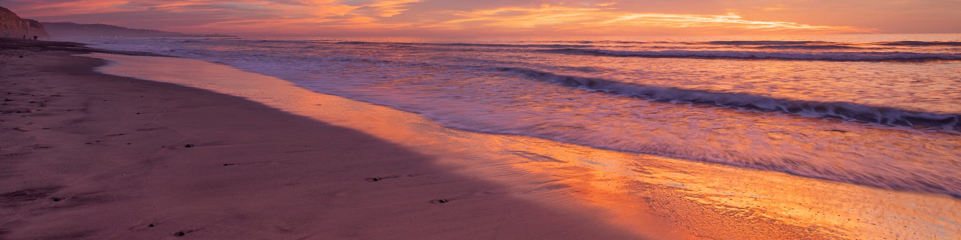 Torrey Pines State Beach which includes general coastal views, a sunset and a sandy beach