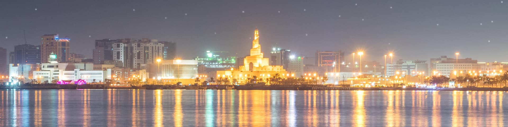 Abdulla Bin Zaid Al Mahmoud Islamic Cultural Center which includes night scenes, a city and a bay or harbor