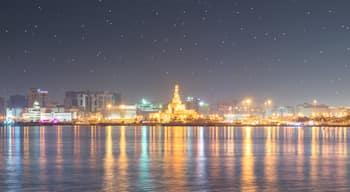 Abdulla Bin Zaid Al Mahmoud Islamic Cultural Center which includes night scenes, a city and a bay or harbor