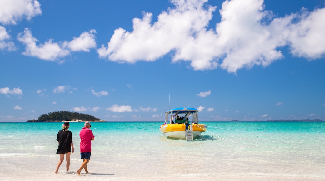 Whitehaven Beach which includes tropical scenes and general coastal views as well as a couple