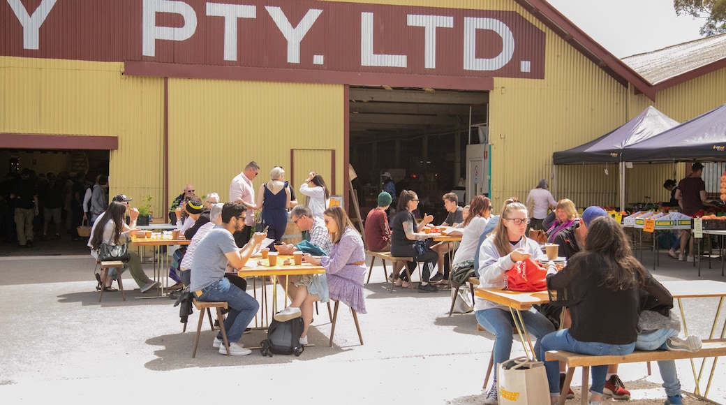 Barossa Farmers Market featuring outdoor eating and signage as well as a small group of people