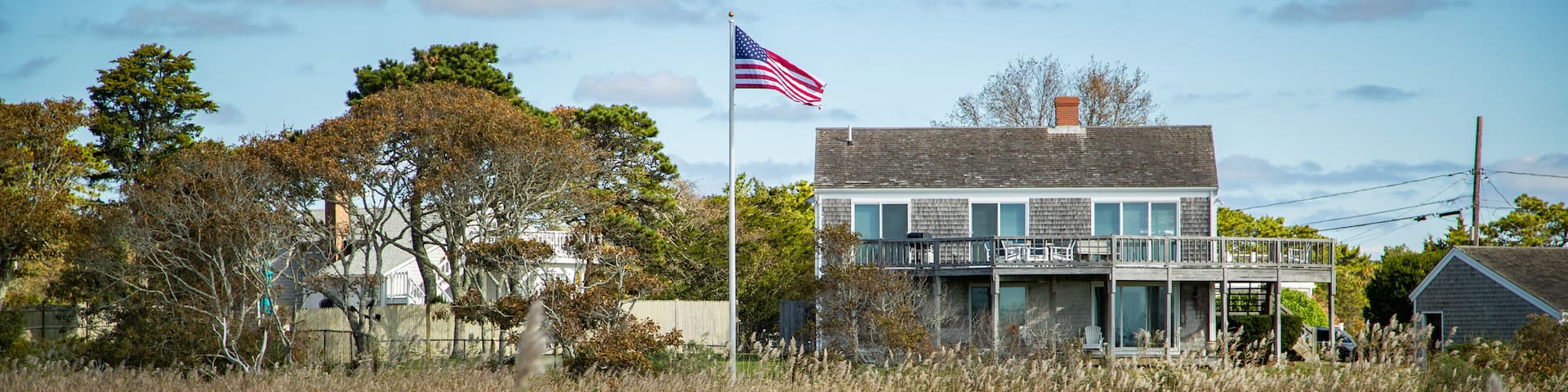 Barnstable County featuring a house, a small town or village and wildflowers