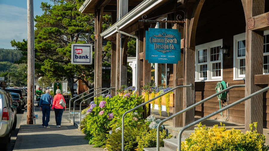 Cannon Beach showing signage and street scenes as well as a couple