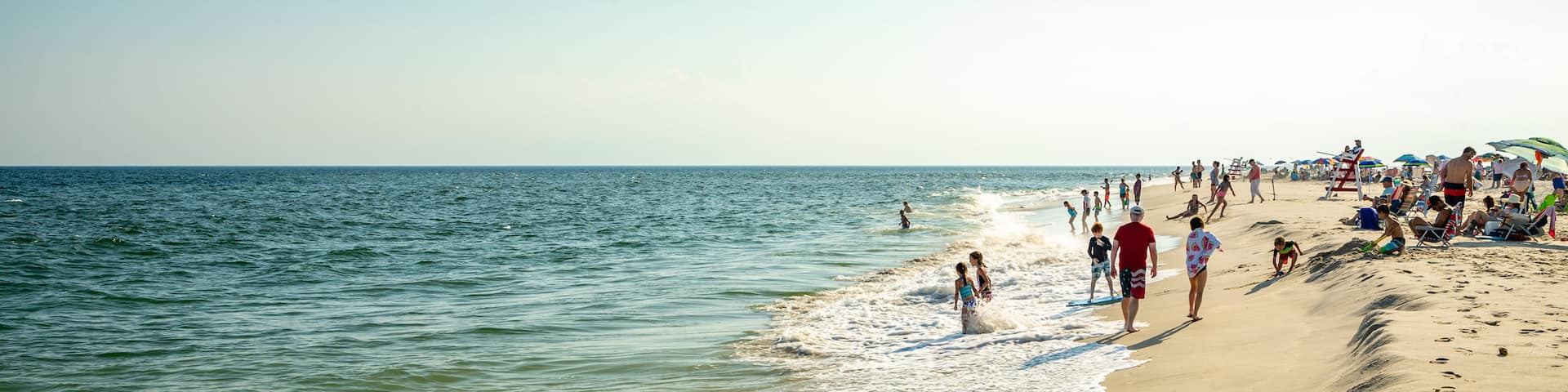 Poverty Beach featuring general coastal views and a sandy beach as well as a large group of people