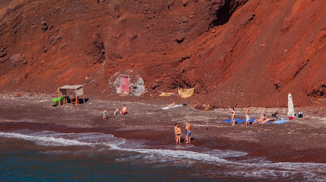 Santorini showing general coastal views and rocky coastline as well as a small group of people