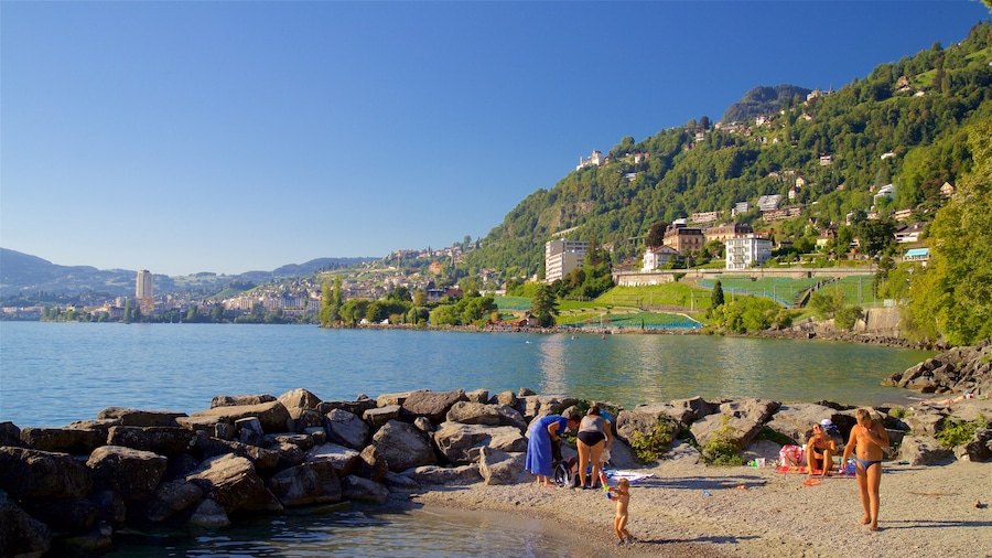 Chateau de Chillon showing a beach and a lake or waterhole as well as a family