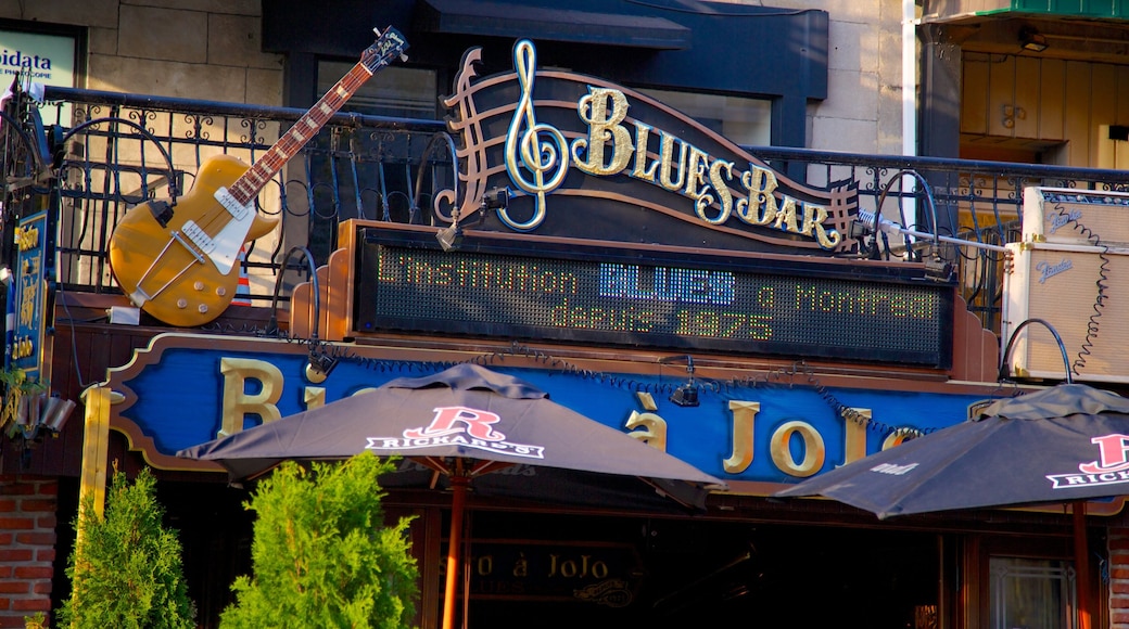 Latin Quarter mostrando música, sinalização e um bar