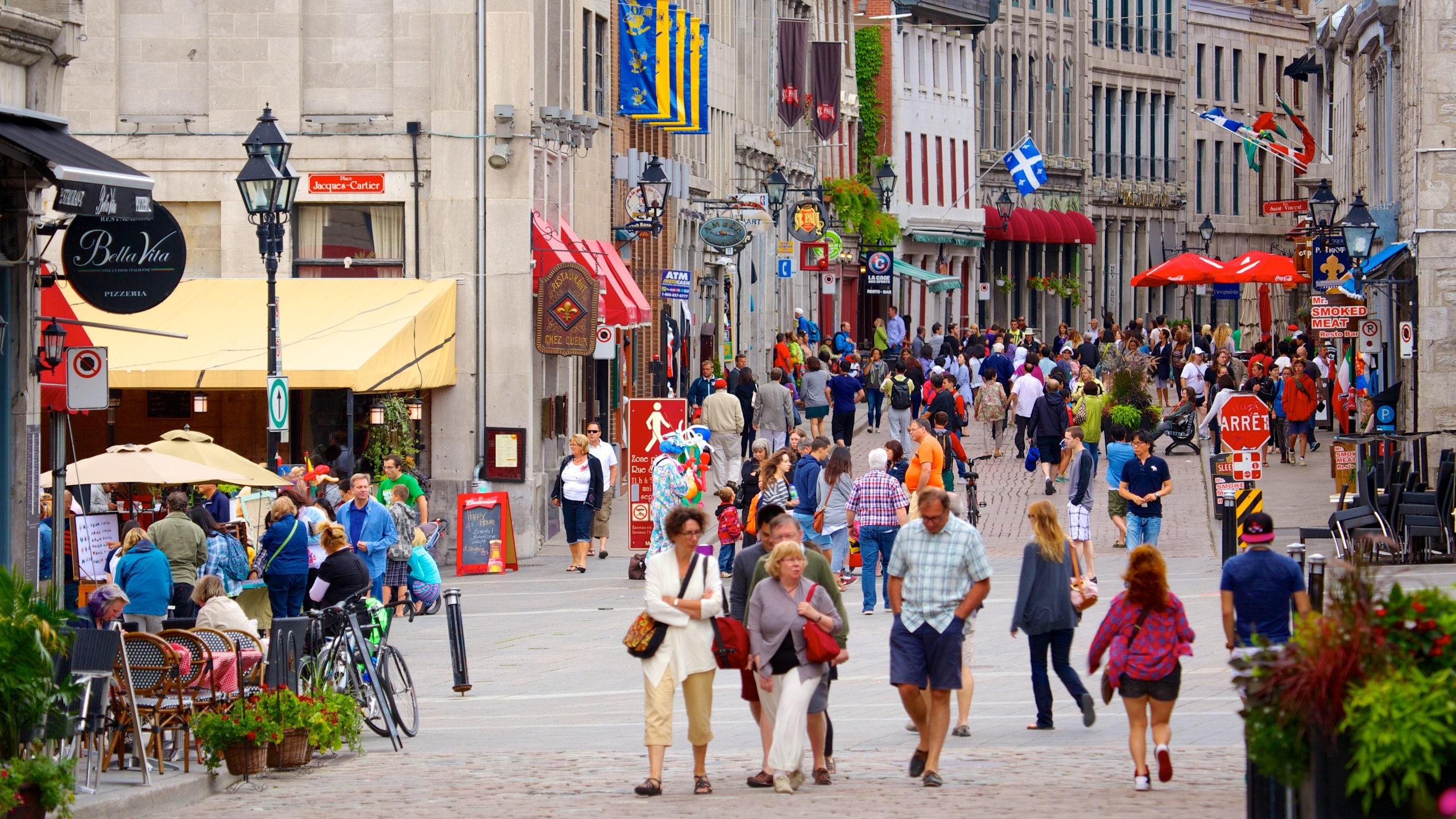 Old Montreal featuring a city and street scenes as well as a large group of people