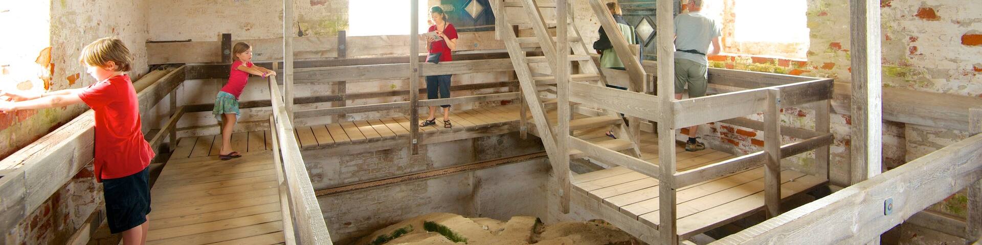 Den Tilsandede Kirke which includes a church or cathedral and interior views as well as children