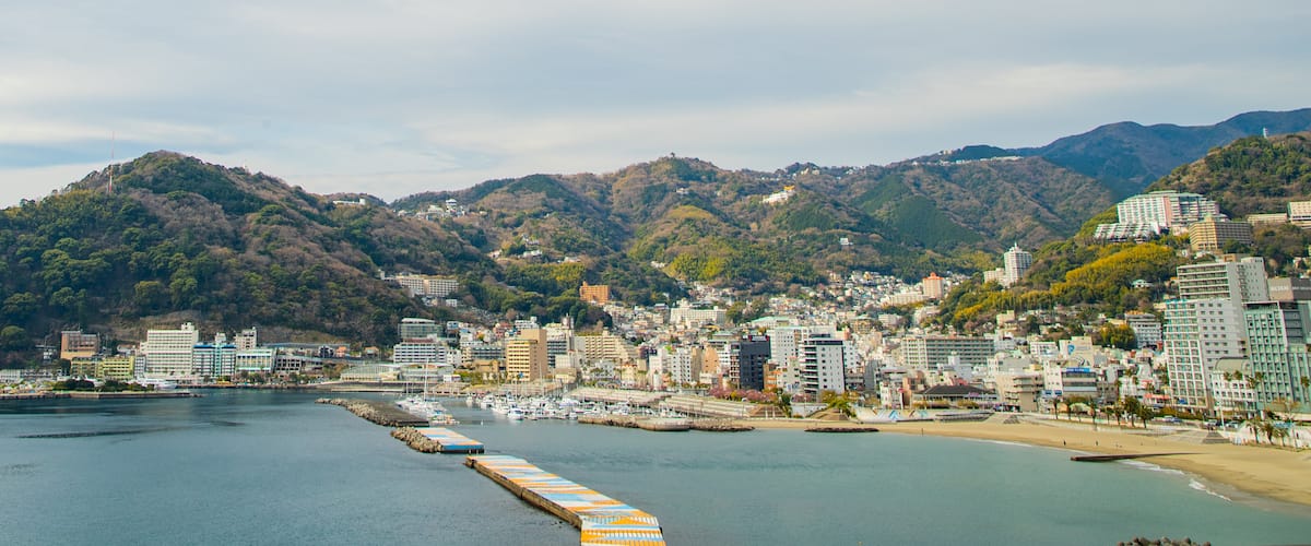 Atami which includes a bay or harbor and a coastal town