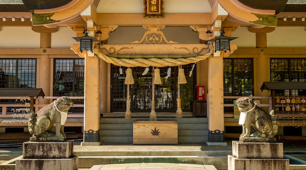 Tatsuta Shrine which includes a statue or sculpture, heritage elements and a temple or place of worship