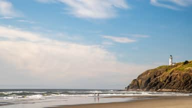 Cape Disappointment State Park showing a sunset, rugged coastline and a sandy beach