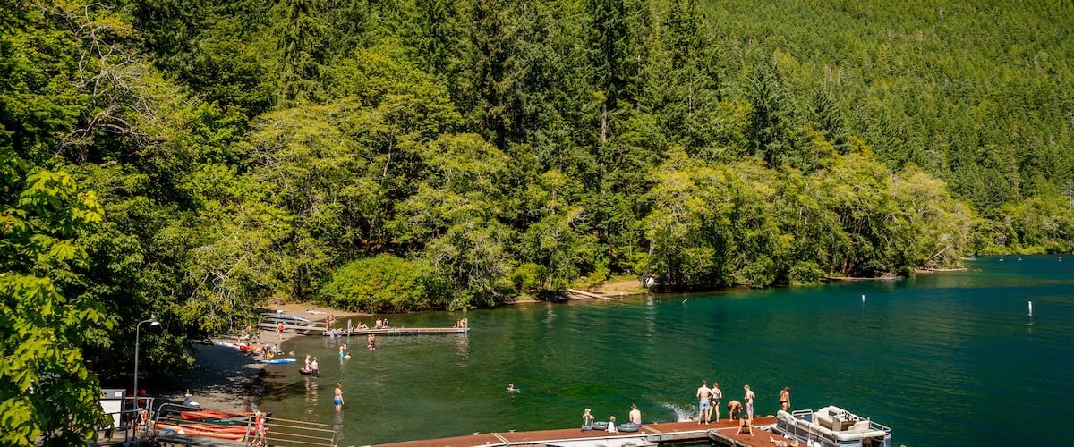 Crescent Beach featuring tranquil scenes and a lake or waterhole as well as a small group of people