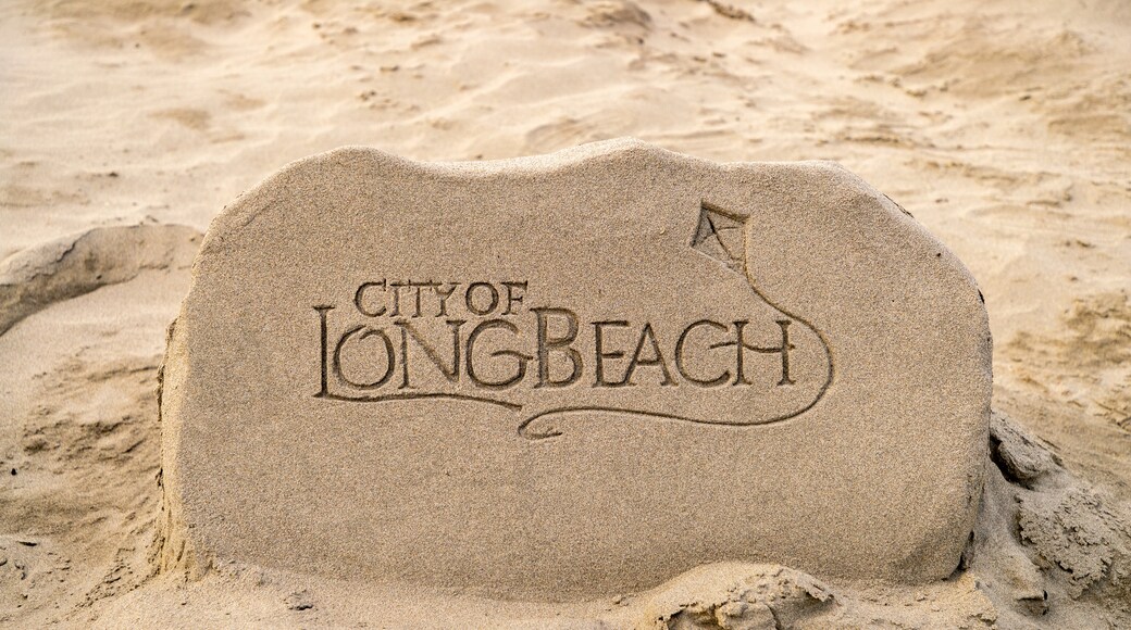 Long Beach which includes outdoor art, a beach and signage