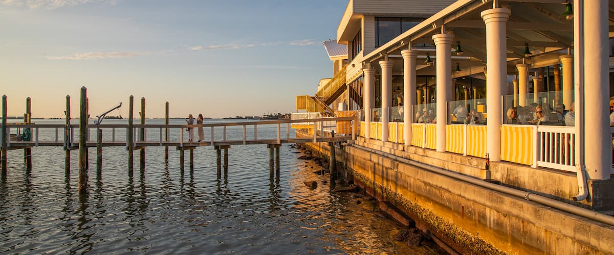 Downtown Dunedin which includes a sunset and general coastal views as well as a couple