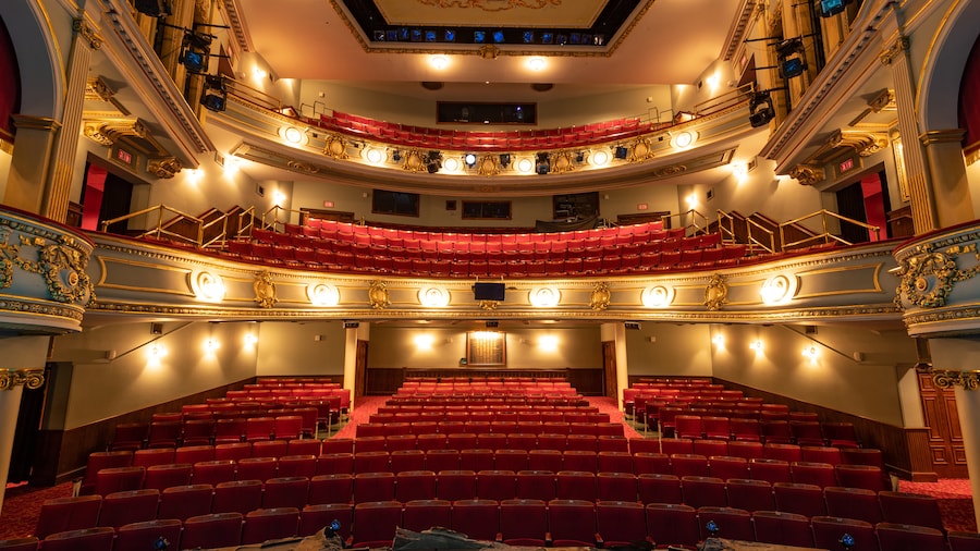 Interior of the historic Savannah Theatre in Savannah, Georgia, featuring red velvet seats, ornate gold-trimmed balconies, and classic stage lighting in one of the oldest operating theaters in the United States
