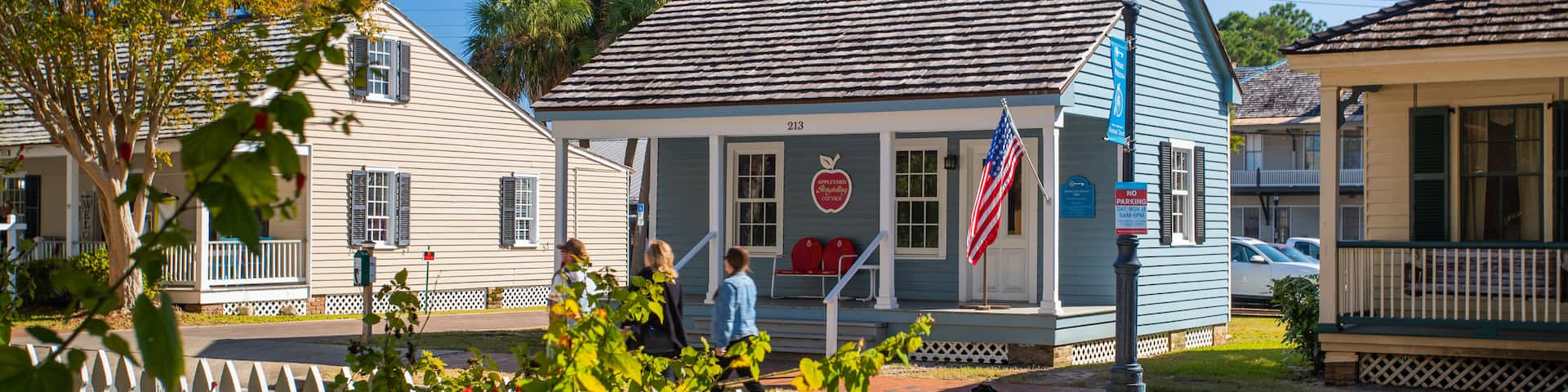 Historic Pensacola Village which includes street scenes and a house as well as a small group of people